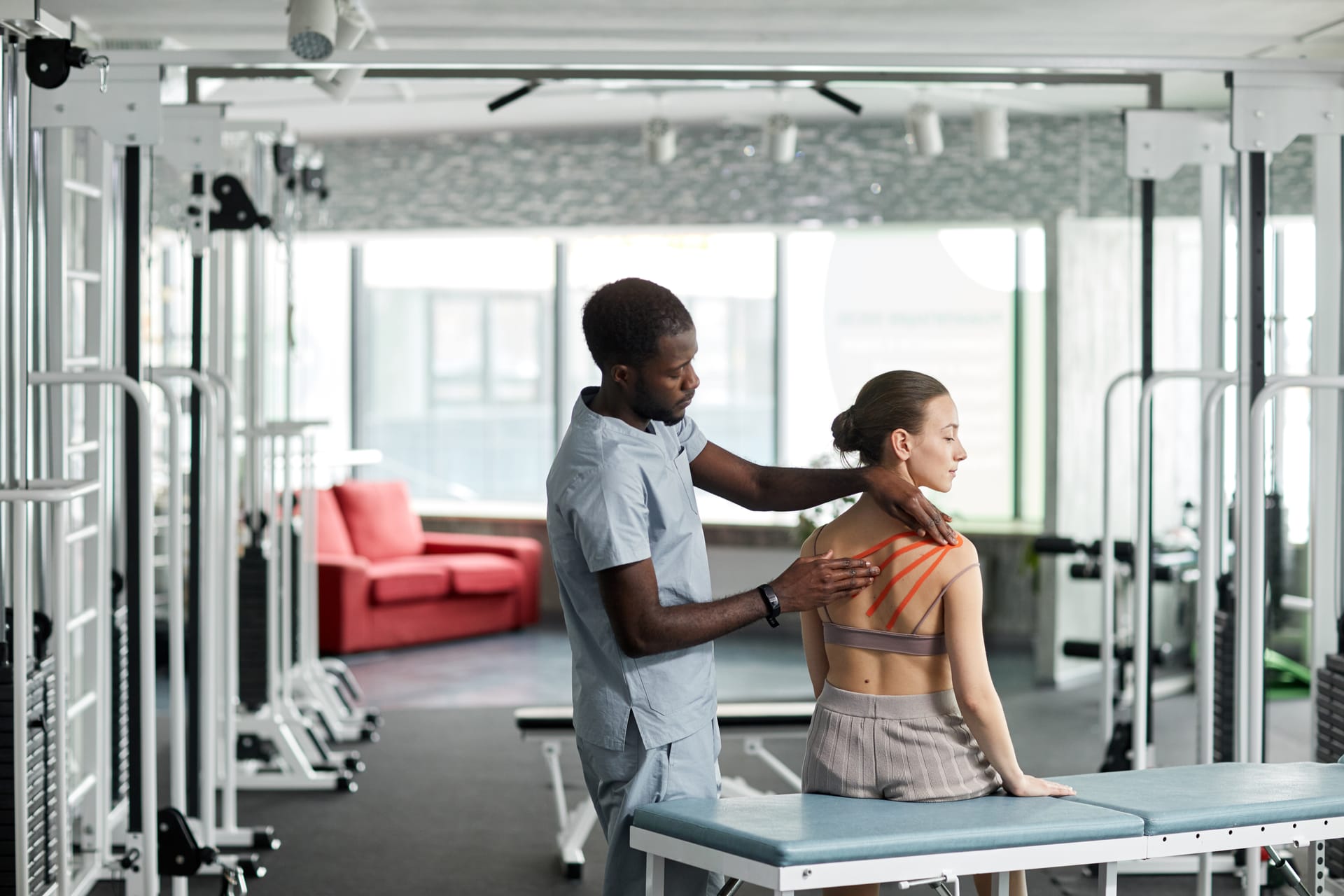 Physiotherapist assessing a patient's shoulder movement during treatment